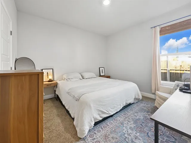 a bedroom with a bed and a television