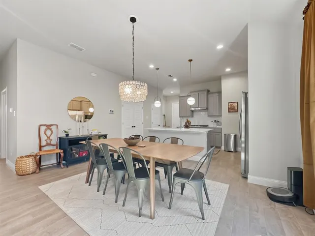 a living room with furniture and two windows