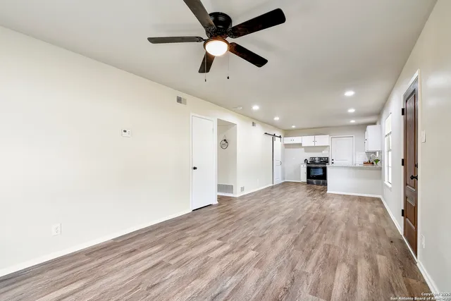 a view of a kitchen with wooden floor and a sink