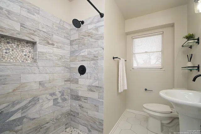 a bathroom with a toilet and a shower