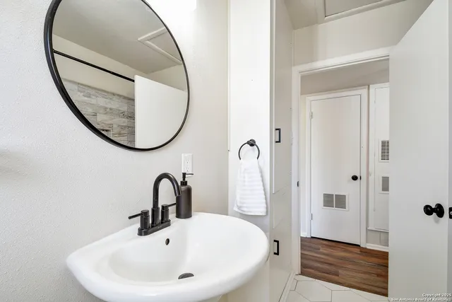 a bathroom with a sink and a mirror