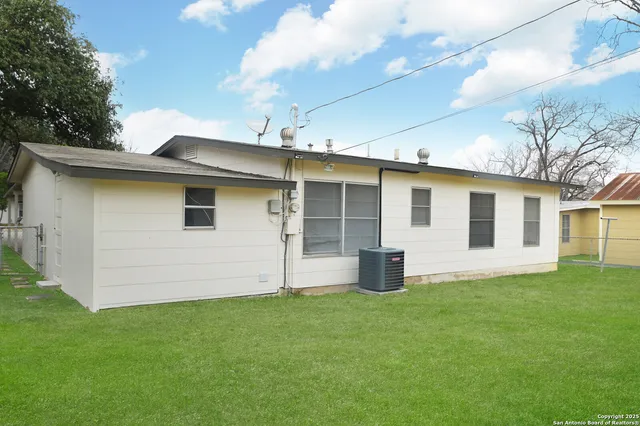 a front view of house with yard and barbeque oven