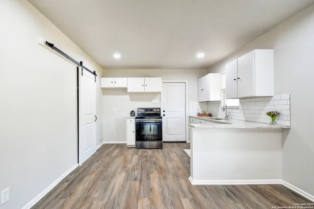 a kitchen with stainless steel appliances a refrigerator and a stove top oven