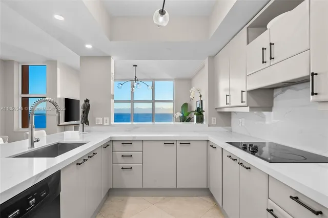 a kitchen with stainless steel appliances kitchen island granite countertop a sink and cabinets