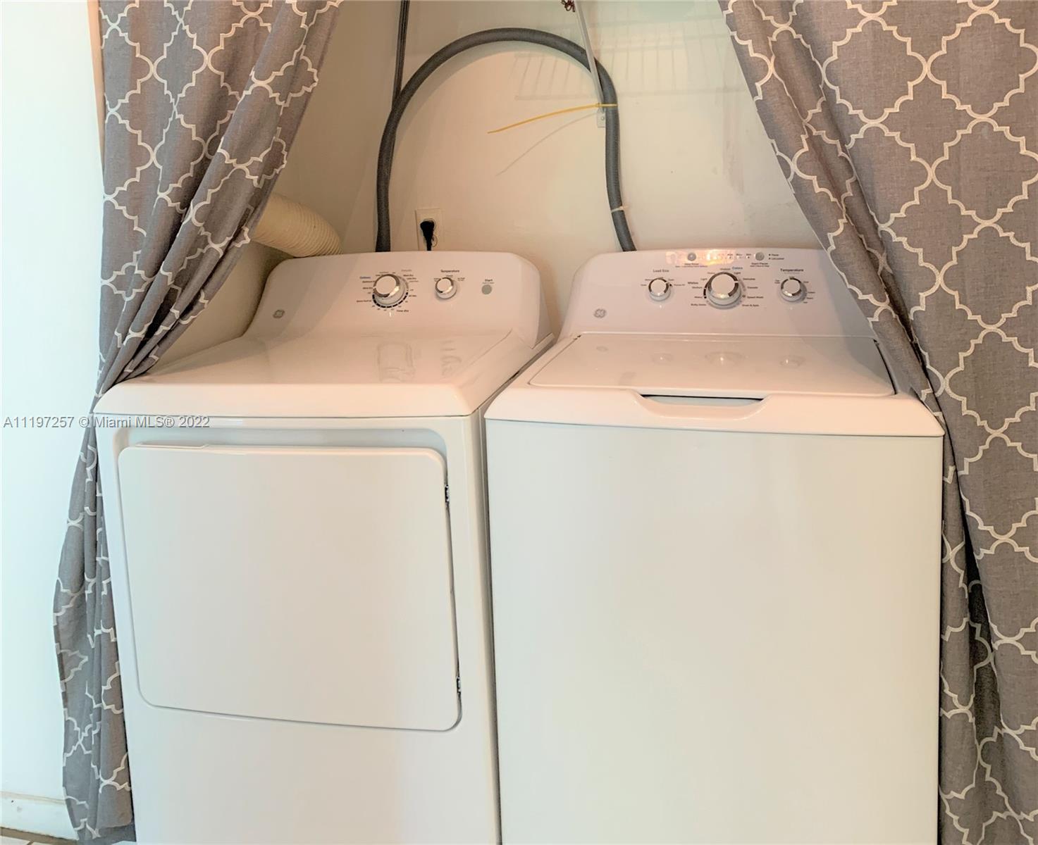 150 Pineview Road, Unit F1 Jupiter, FL 33469 - Photo 8 of 8 a utility room with dryer and washer