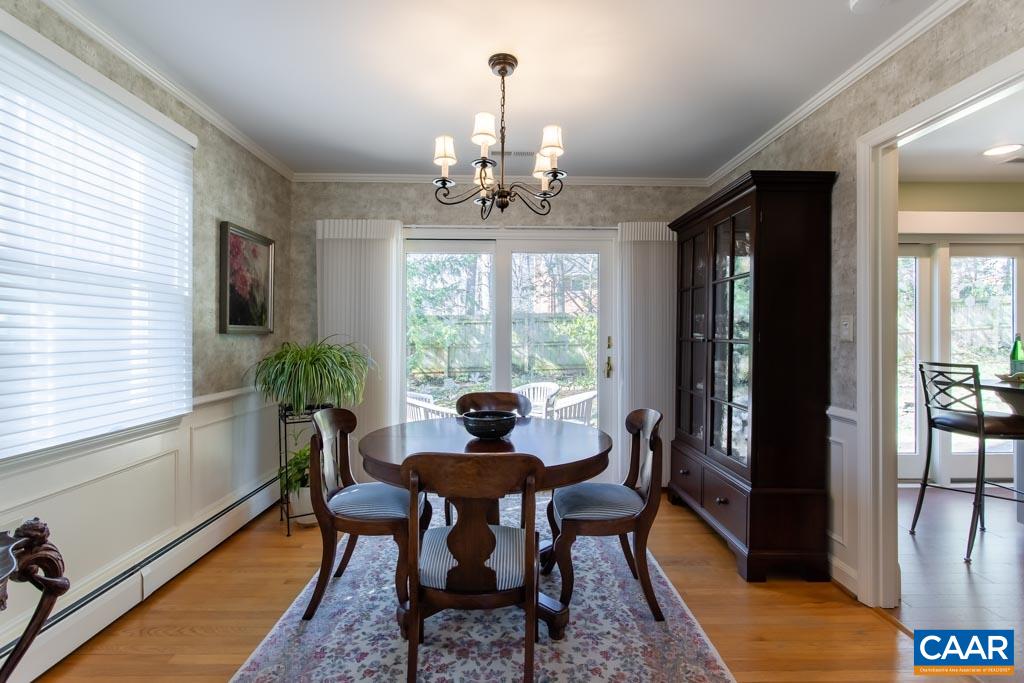 2412 Brook Road Charlottesville, VA 22901 - Photo 5 of 24 a dining room with furniture a chandelier and wooden floor