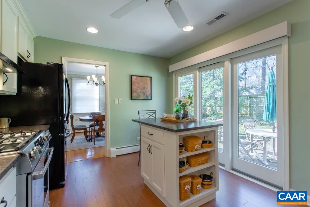 2412 Brook Road Charlottesville, VA 22901 - Photo 8 of 24 a kitchen with a stove a refrigerator and wooden floor