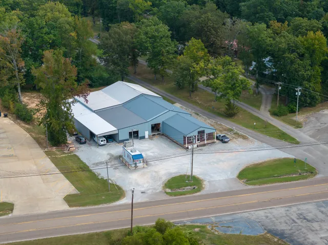 an aerial view of a house with swimming pool and patio