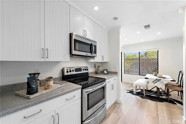 a kitchen with a sink a stove and cabinets