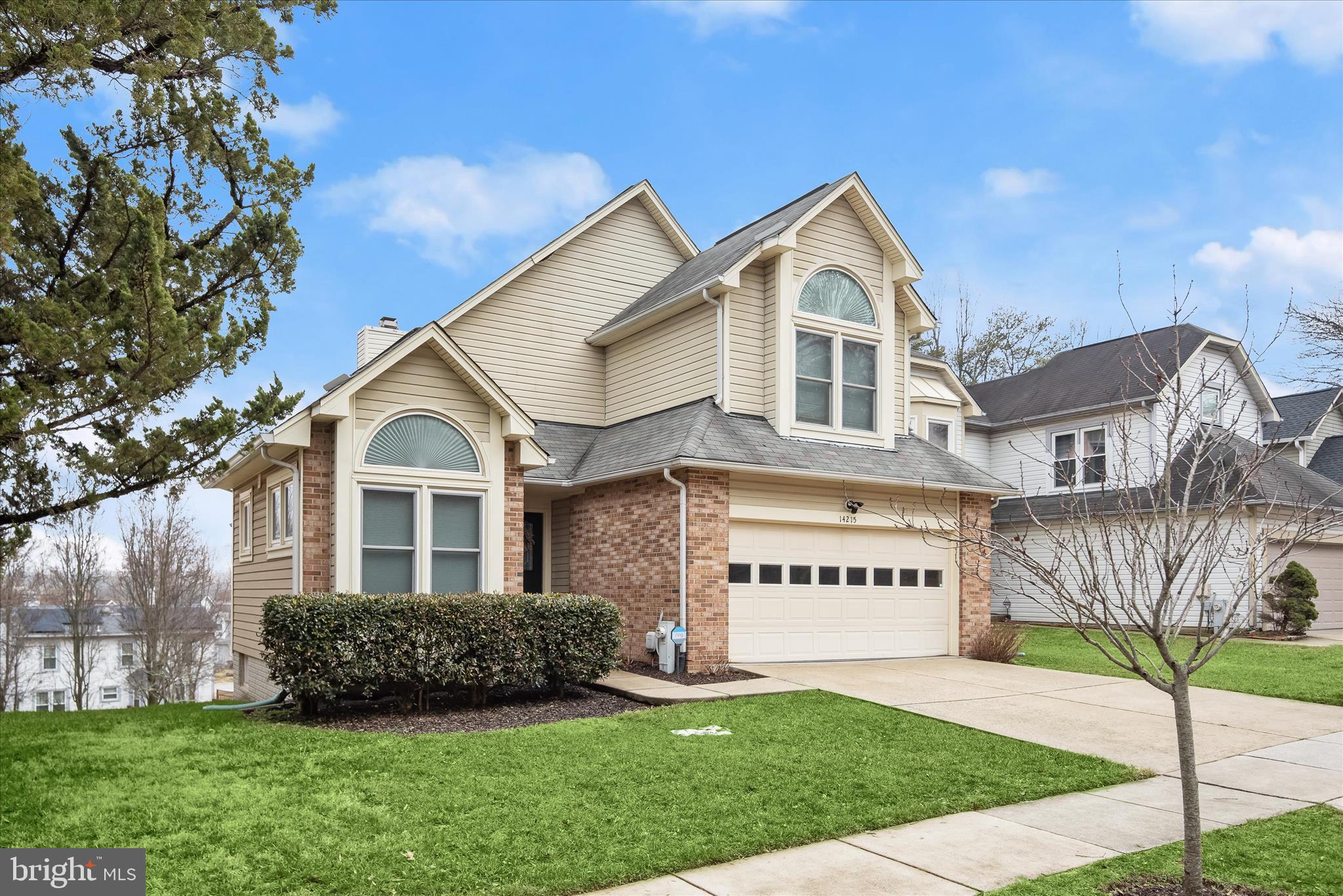 a front view of a house with a garden and plants