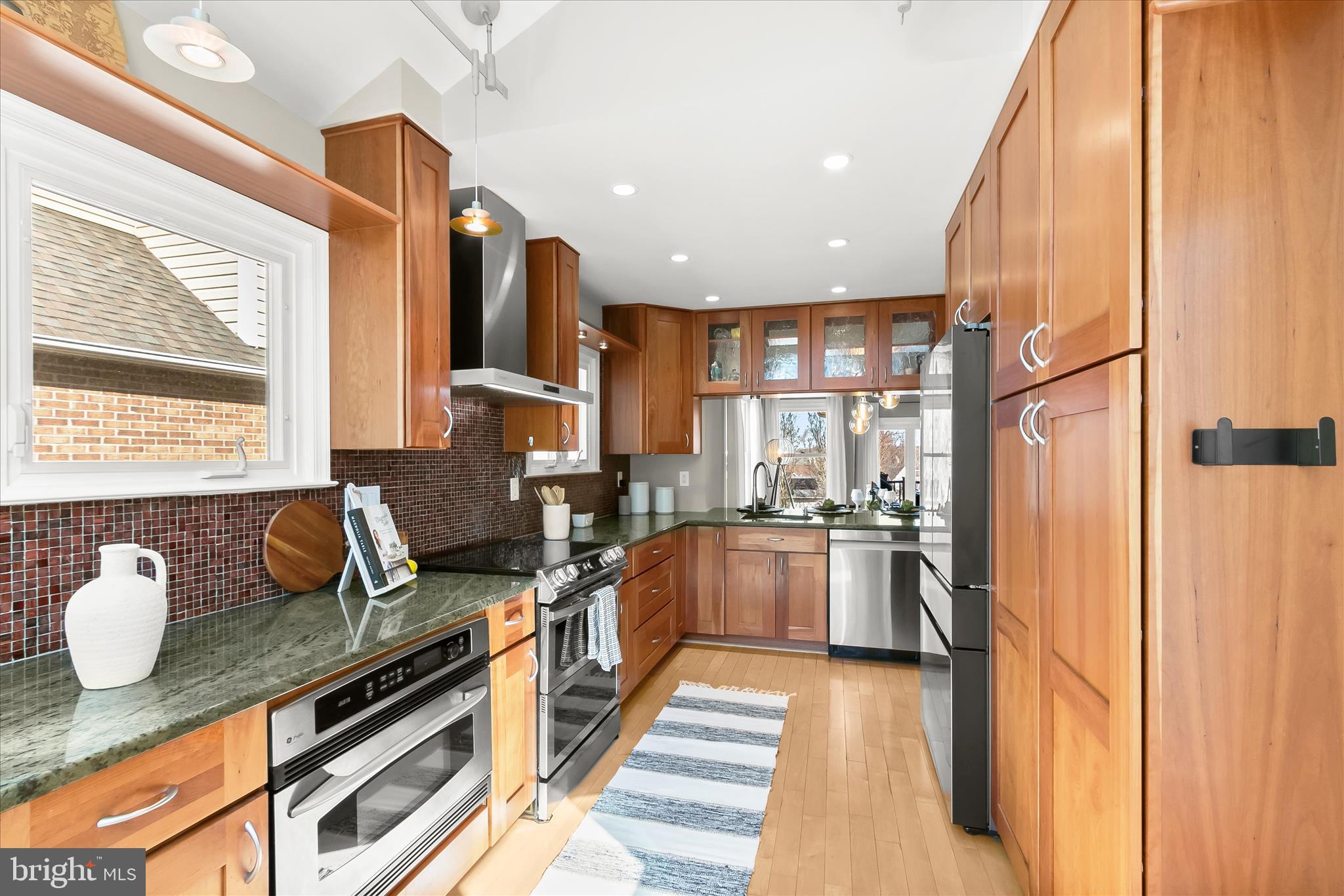 14215 Summit Lane Laurel, MD 20708 - Photo 11 of 62 a kitchen with stainless steel appliances granite countertop a stove a sink and a refrigerator
