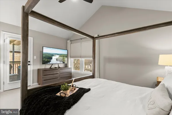a bedroom with a bed and a lamp