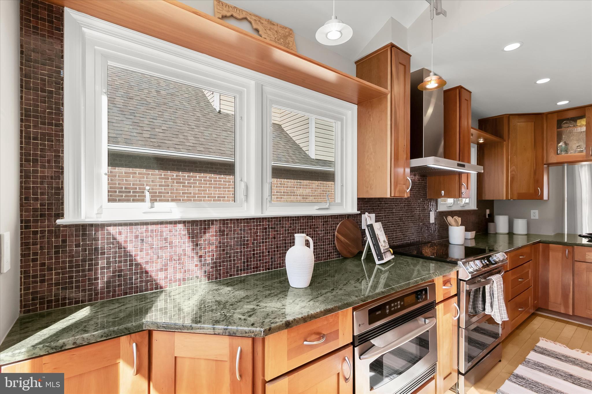 14215 Summit Lane Laurel, MD 20708 - Photo 10 of 62 a kitchen with granite countertop a stove a sink and a granite counter tops