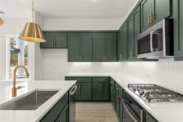 a kitchen with a sink stove and cabinets