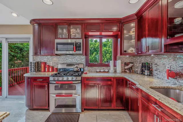 a kitchen with a stove a sink and a microwave