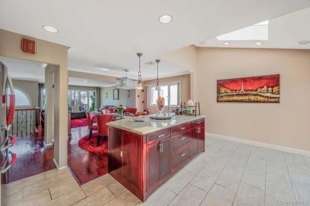 a view of kitchen with stainless steel appliances granite countertop a stove and a refrigerator