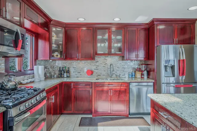 a kitchen with stainless steel appliances granite countertop a sink dishwasher stove and cabinets