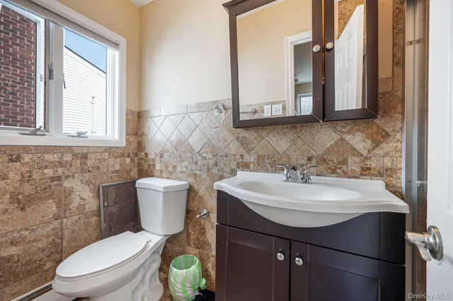 a bathroom with a sink a toilet and mirror