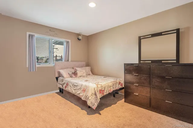 a bedroom with a bed and a mirror