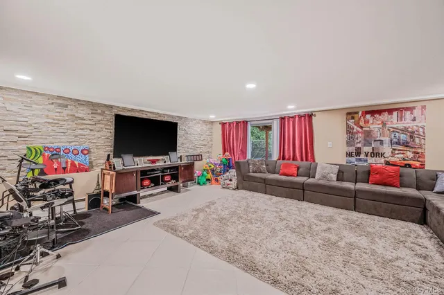 a living room with furniture and couches with kitchen view