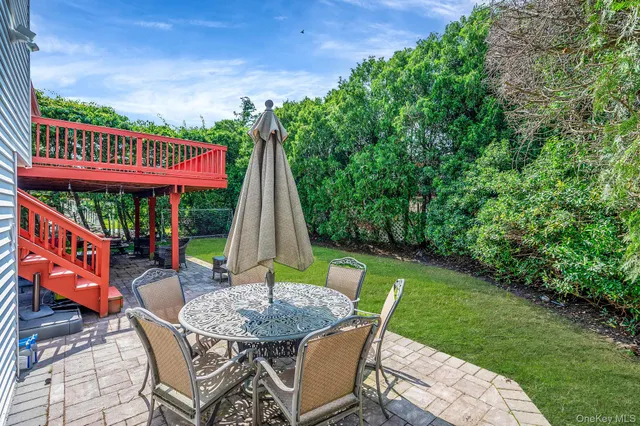 a view of a table and chairs in backyard of the house