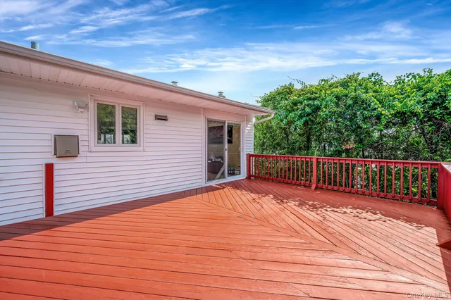 a view of backyard with a deck