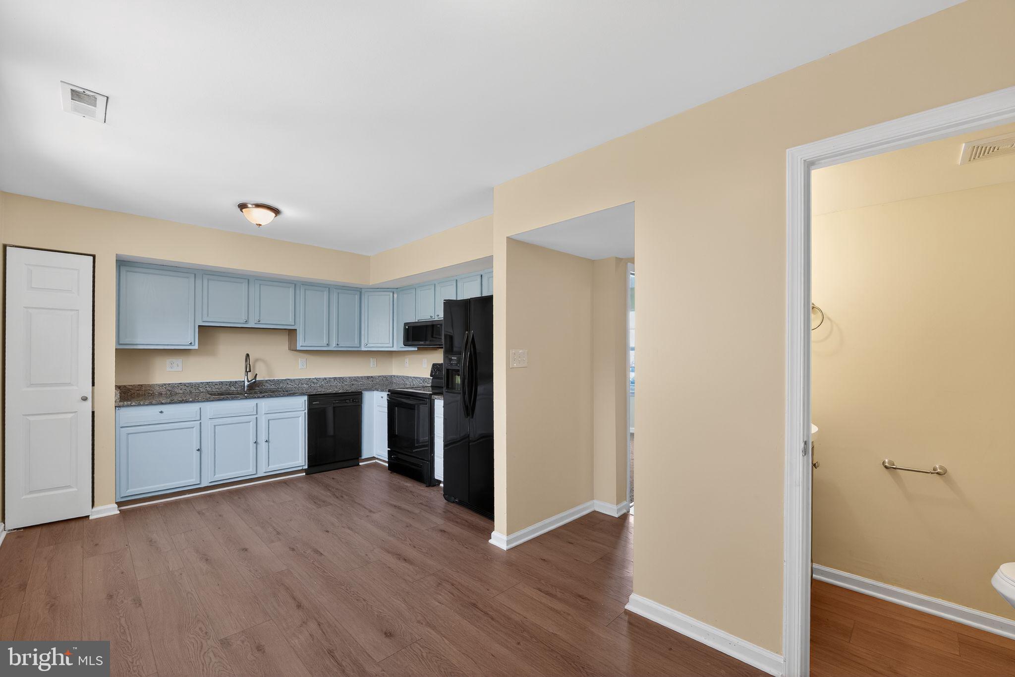 8090 Round Table Court Pasadena, MD 21122 - Photo 15 of 31 a kitchen with a refrigerator and a stove top oven