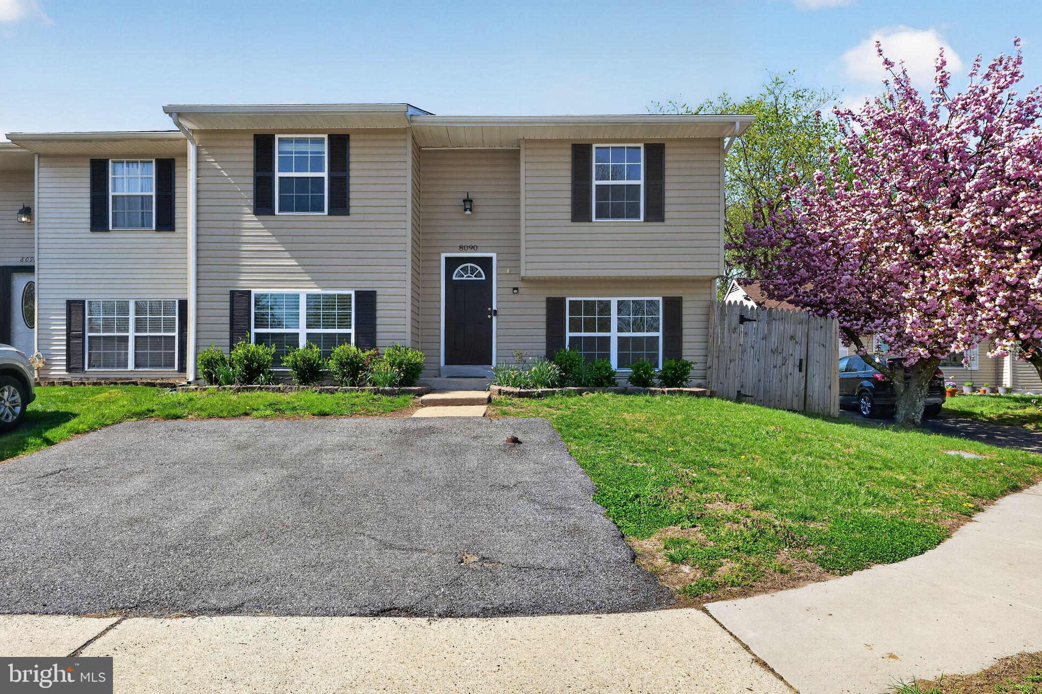 8090 Round Table Court Pasadena, MD 21122 - Photo 2 of 31 a front view of a house with a yard and trees