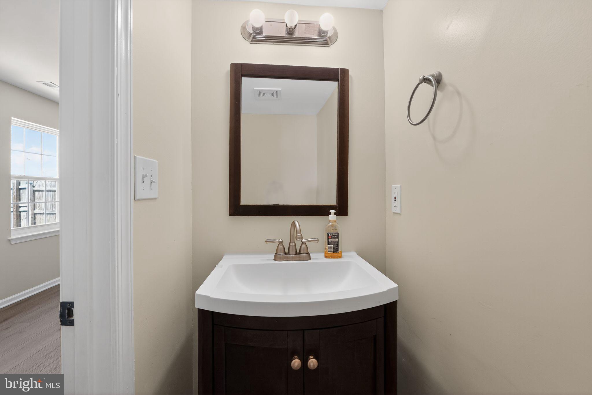 8090 Round Table Court Pasadena, MD 21122 - Photo 25 of 31 a bathroom with a sink and a mirror