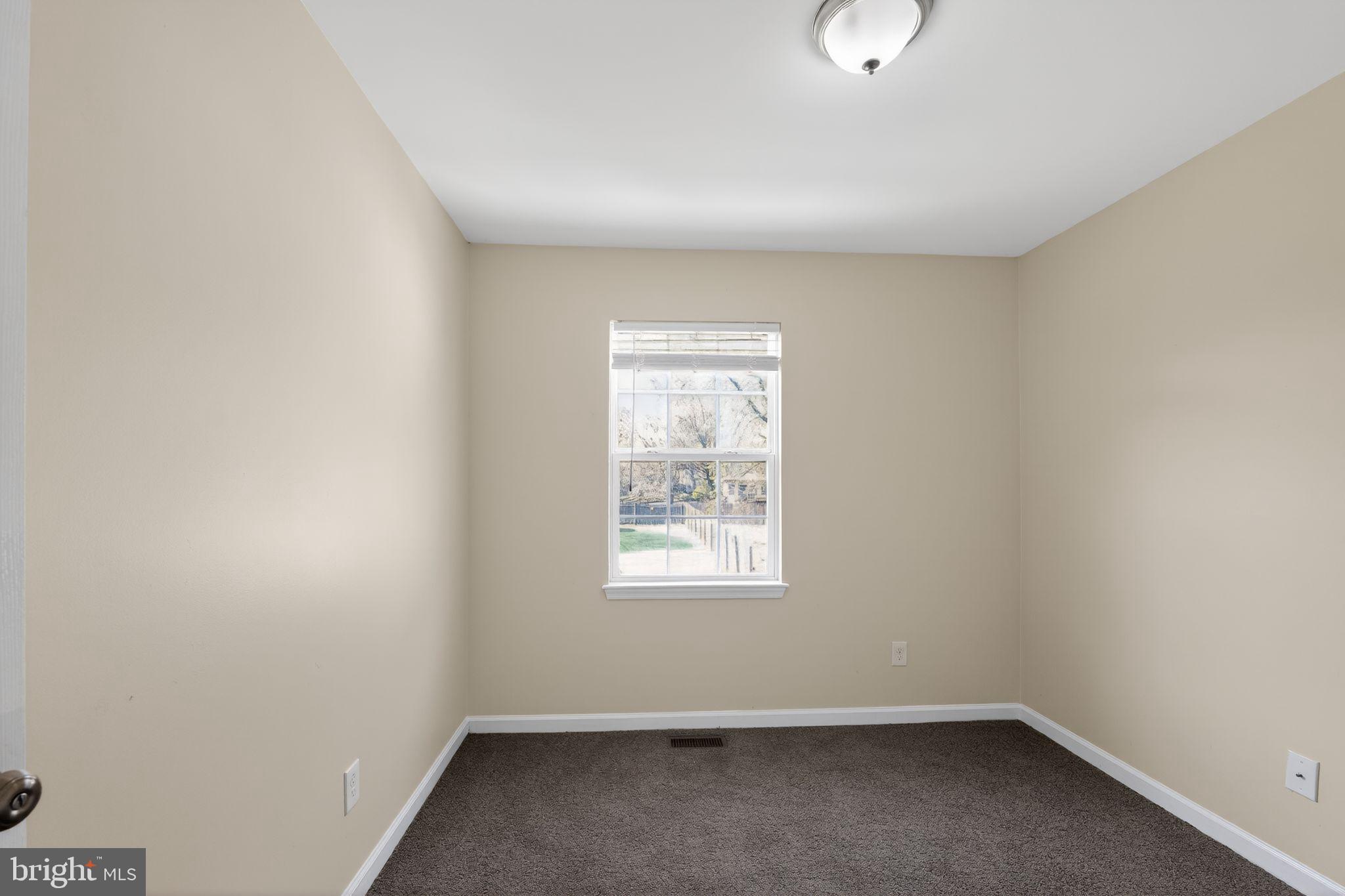 8090 Round Table Court Pasadena, MD 21122 - Photo 6 of 31 an empty room with a window