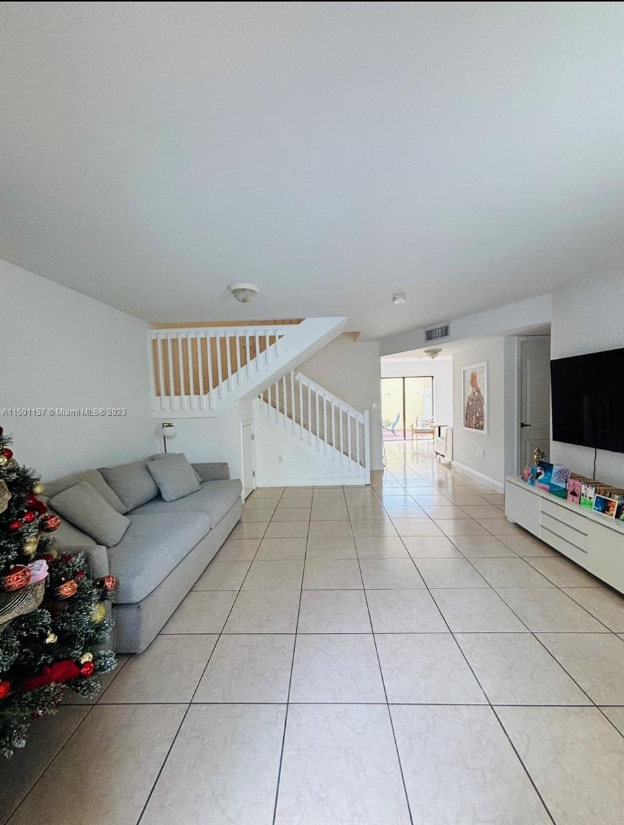 11115 West Okeechobee Road, Unit 181 Hialeah Gardens, FL 33018 - Photo 1 of 31 a living room with furniture and a flat screen tv