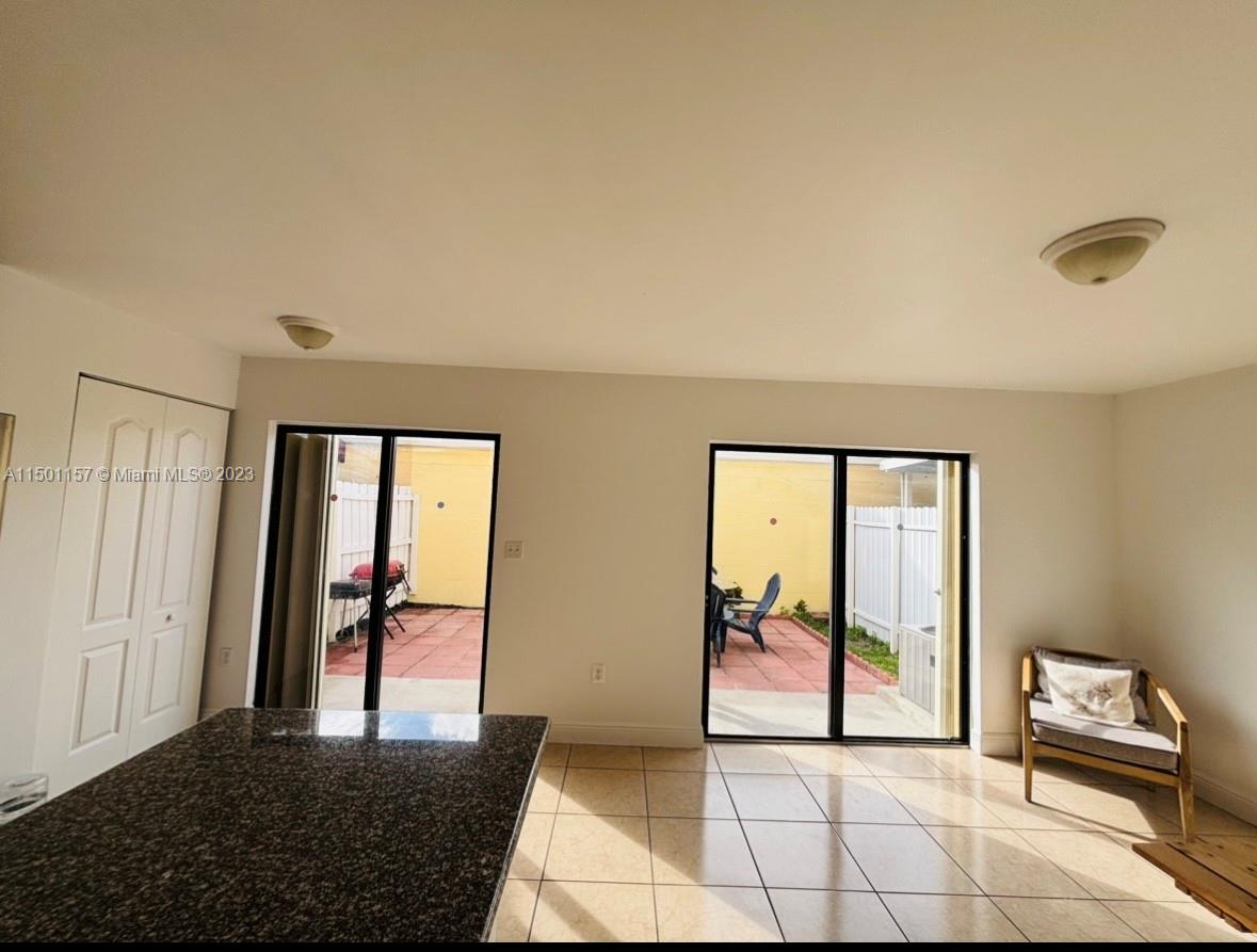 11115 West Okeechobee Road, Unit 181 Hialeah Gardens, FL 33018 - Photo 11 of 31 a view of a hallway with furniture and a window