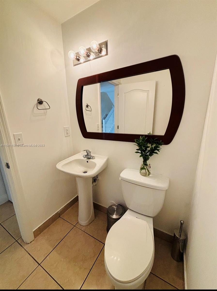 11115 West Okeechobee Road, Unit 181 Hialeah Gardens, FL 33018 - Photo 13 of 31 a bathroom with a toilet sink and mirror