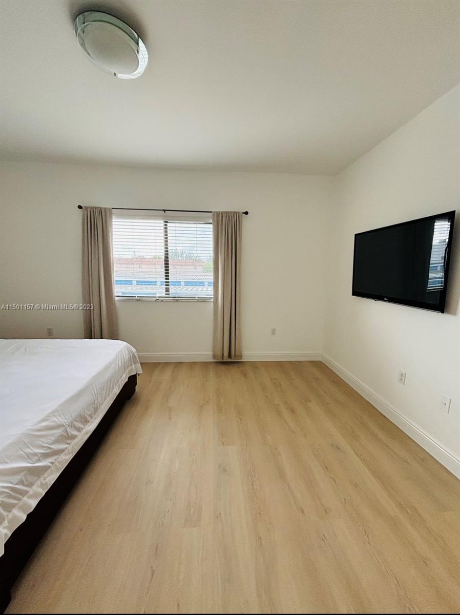 11115 West Okeechobee Road, Unit 181 Hialeah Gardens, FL 33018 - Photo 15 of 31 a bedroom with a bed and window