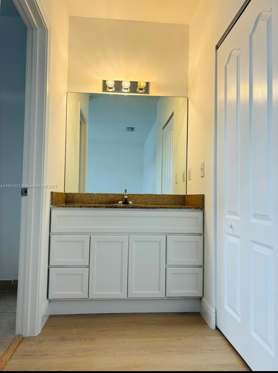 11115 West Okeechobee Road, Unit 181 Hialeah Gardens, FL 33018 - Photo 18 of 31 a bathroom with a sink and a mirror