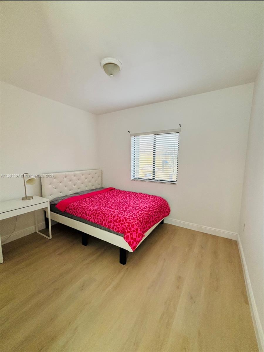 11115 West Okeechobee Road, Unit 181 Hialeah Gardens, FL 33018 - Photo 21 of 31 a bedroom with a bed and window