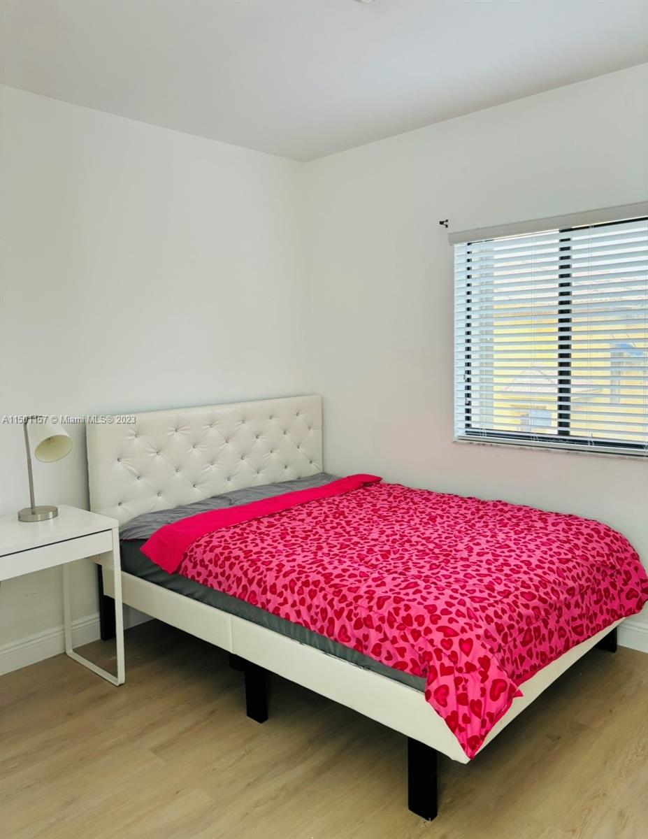 11115 West Okeechobee Road, Unit 181 Hialeah Gardens, FL 33018 - Photo 22 of 31 a bedroom with a bed and a window