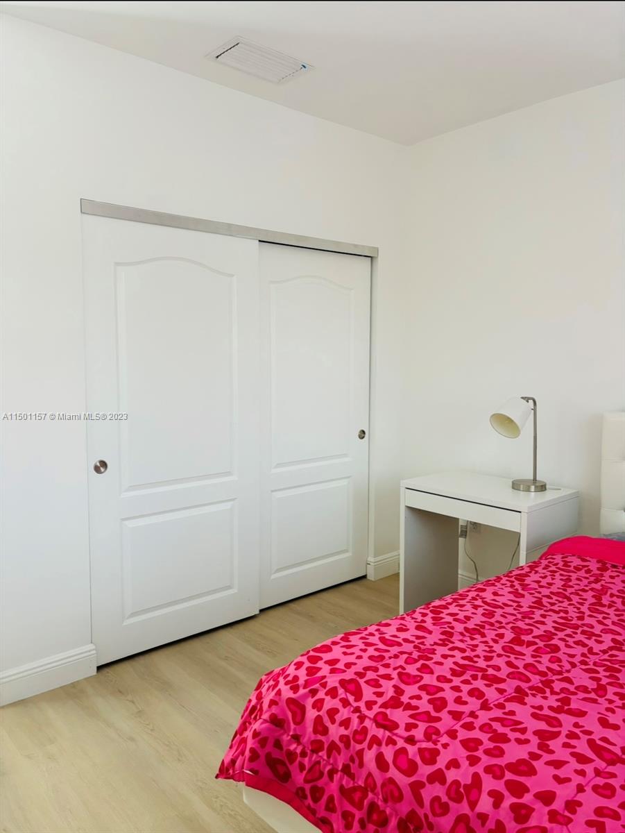 11115 West Okeechobee Road, Unit 181 Hialeah Gardens, FL 33018 - Photo 23 of 31 a bedroom with a bed and a table