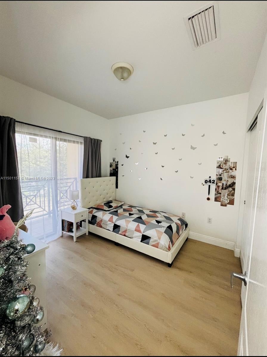 11115 West Okeechobee Road, Unit 181 Hialeah Gardens, FL 33018 - Photo 26 of 31 a bedroom with furniture and window