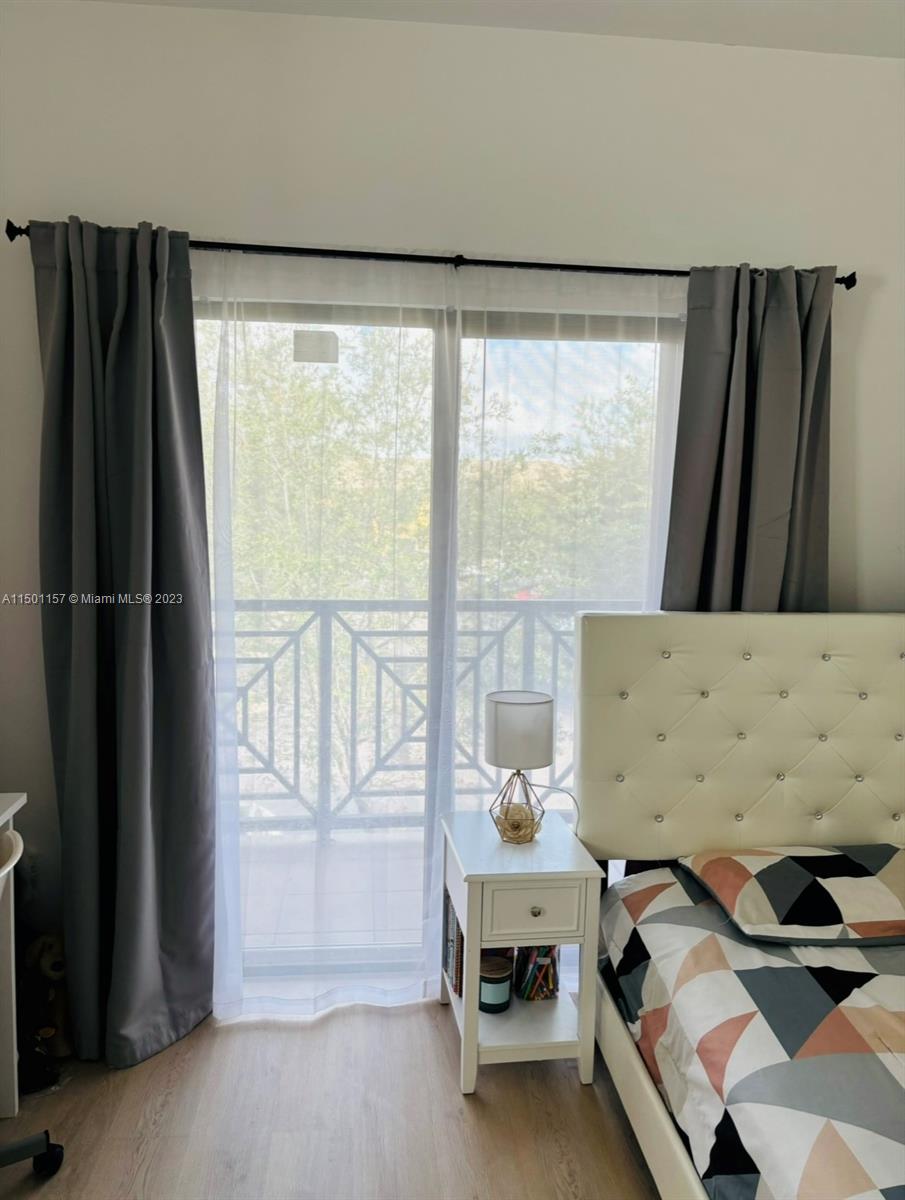 11115 West Okeechobee Road, Unit 181 Hialeah Gardens, FL 33018 - Photo 27 of 31 a bedroom with a bed and a window