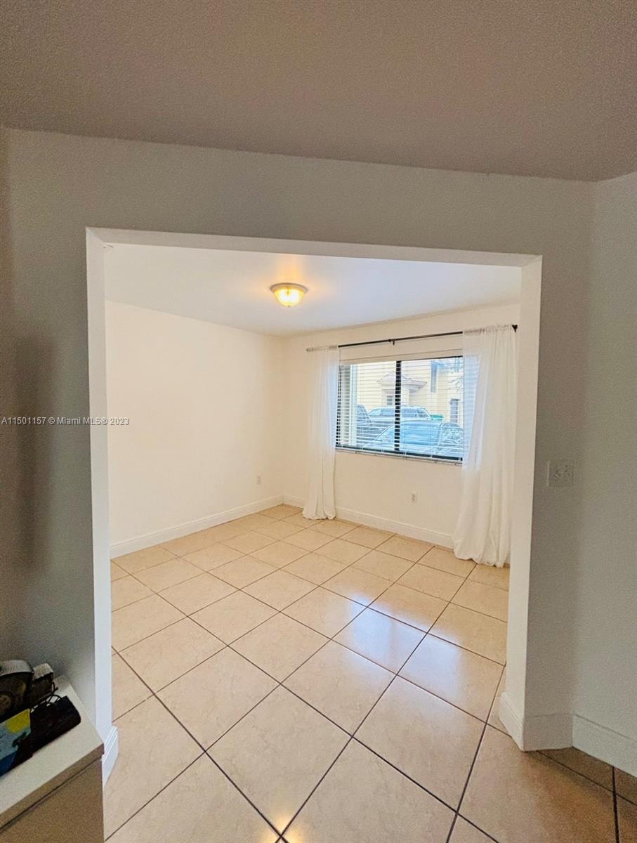 11115 West Okeechobee Road, Unit 181 Hialeah Gardens, FL 33018 - Photo 6 of 31 a view of an empty room and window