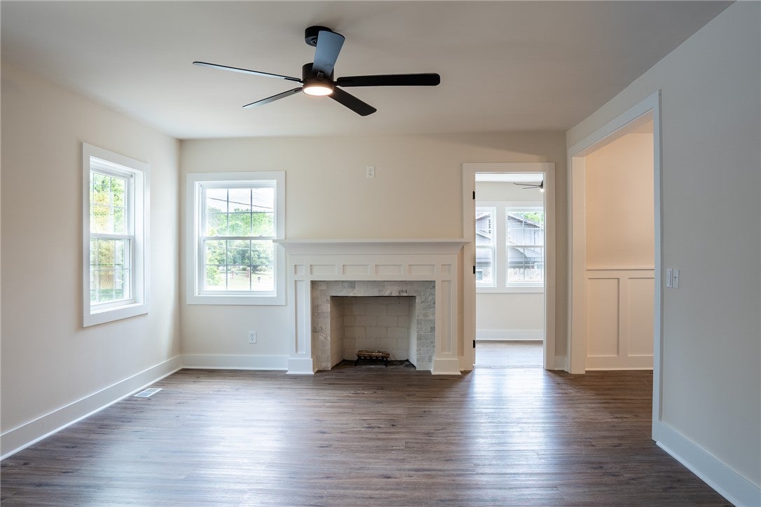 1312 Rocky Brook Road Opelika, AL 36801 - Photo 7 of 45 This bright living space features hardwood flooring and a classic fireplace.