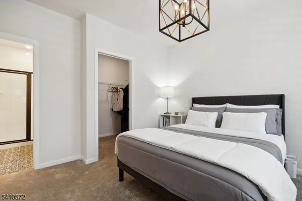 a bedroom with a bed and a painting