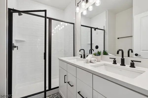 a bathroom with a double vanity sink mirror and double