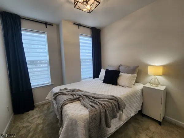 a bedroom with a bed and a lamp