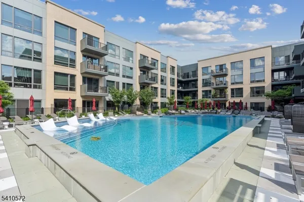 a view of swimming pool with outdoor seating