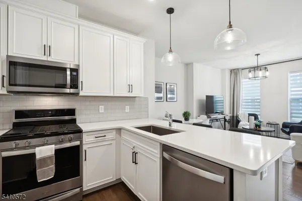 a kitchen that has a sink and a stove top oven