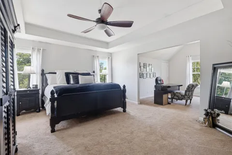 a work room with furniture a rug and a window