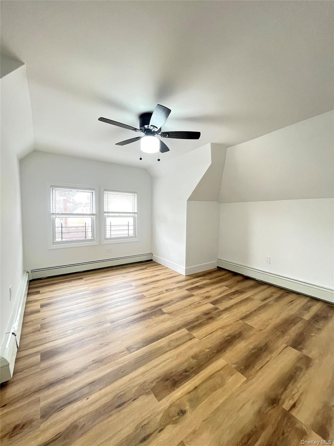 123 Clinton Avenue, Unit 2 New Rochelle, NY 10801 - Photo 14 of 27 a view of empty room with wooden floor and fan