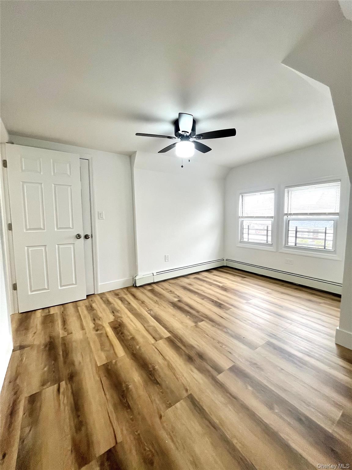 123 Clinton Avenue, Unit 2 New Rochelle, NY 10801 - Photo 16 of 27 a view of empty room with wooden floor and fan